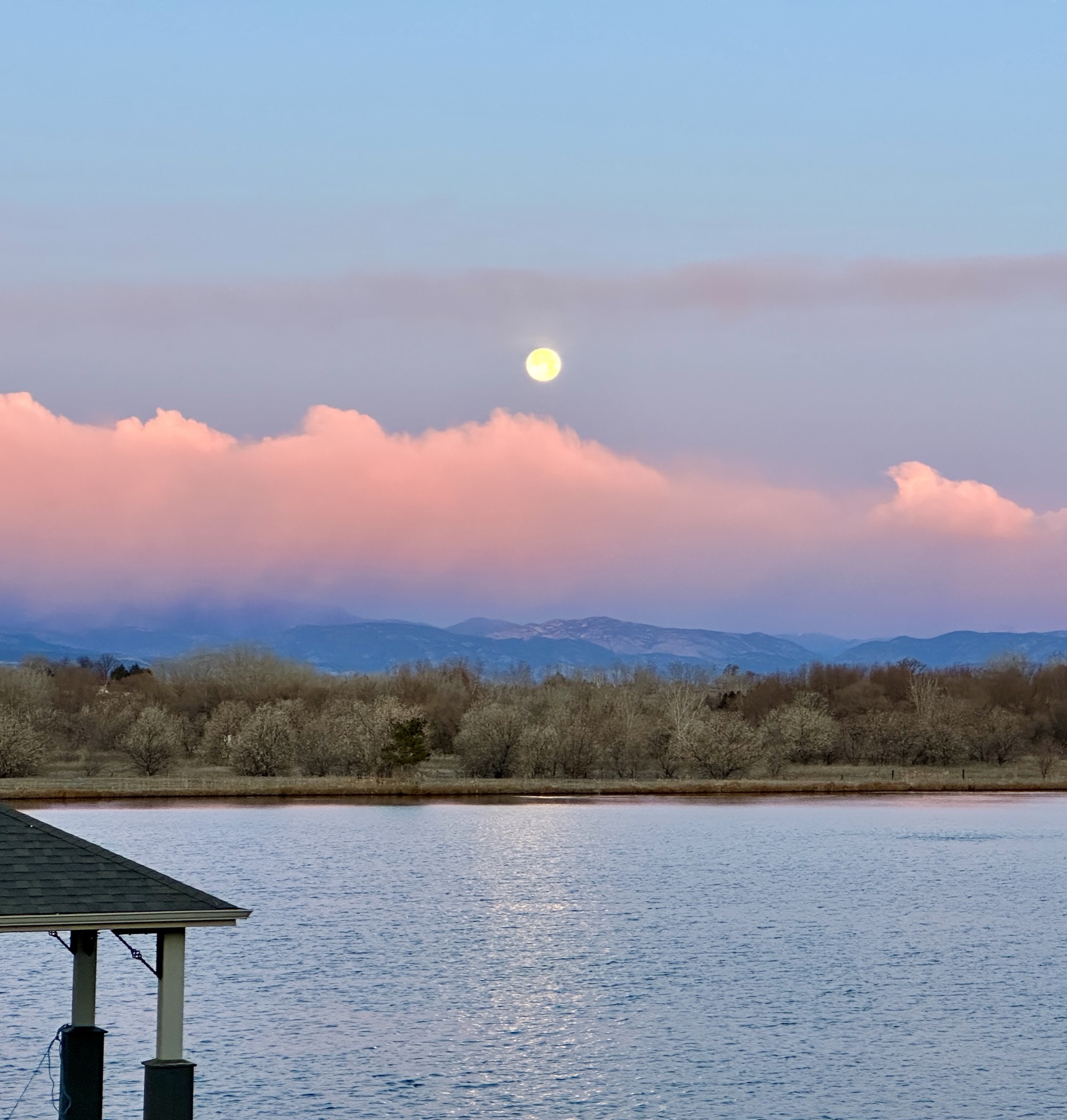 Mirror-like reflections on the lake surface at dusk